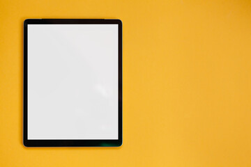Fototapeta premium Tablet screen mockup isolated on yellow background, top view