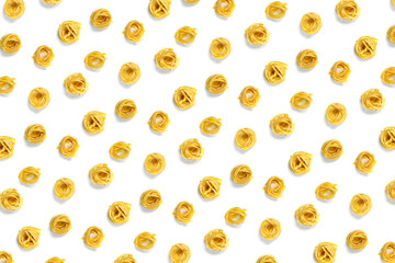 background from Italian tagliatelle pasta. raw pasta fettuccine, pop art background, flat lay. Italian raw nest pasta isolated on white. not seamless pattern