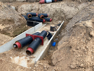 Large industrial modern new large diameter polyethylene plastic water pipes lie in a pit...