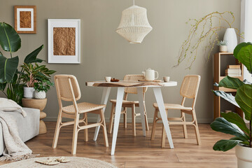 Stylish interior of dining room at cozy home with white mock up poster frame, design chairs, family...