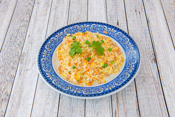 Three Chinese delicacies rice inside a beautiful plate with blue border