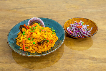 Peruvian recipe of rice with seafood. Scallops, prawns, shrimp, squid, pepper, mussels, red onion