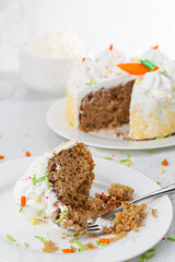 Carrot cake with icing and sprinkles at an Easter party