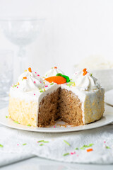 Carrot cake with icing and sprinkles at an Easter party