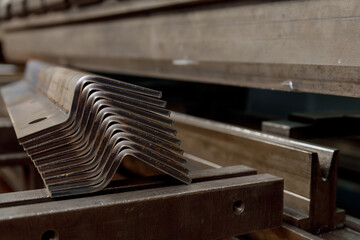 Metal products bent on a bending machine. - obrazy, fototapety, plakaty