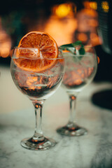 Two gin tonic standing on a bar counter