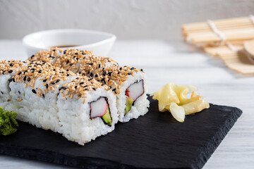 Fresh homemade delivery sushi nigiri seaweed rice roll with avocado crab stick sesame ginger wasabi and traditional soy sauce from a Japanese restaurant in Germany Europe