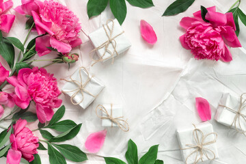 Beautiful delicate pink peonies on the background of vintage wrapping paper. Minimal concept...