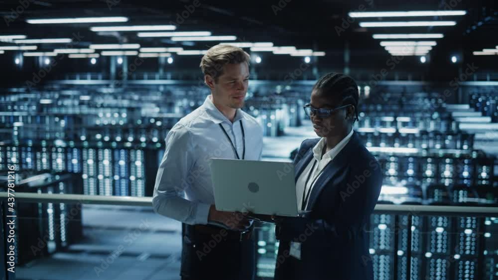 Poster data center female system administrator and male it specialist talk, use laptop. information technol