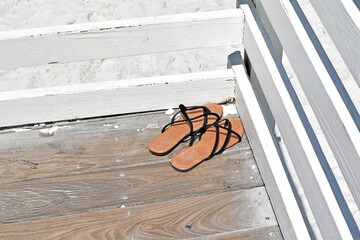 Sandals on a Deck Overlooking the Beach