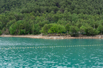 San Ponç lake landscape with turquoise water and yellow buoys