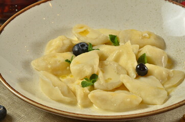 Lazy dumplings of cottage cheese with sour cream and berries