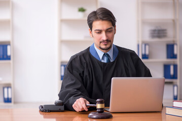 Young male judge working in the courtroom