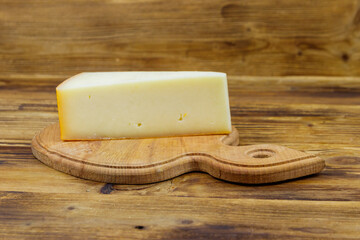 Piece of cheese on a wooden table