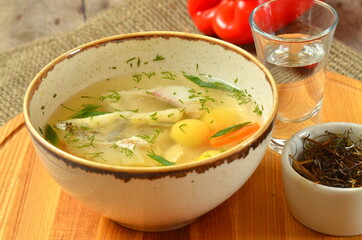 fish soup on rustic wooden table background