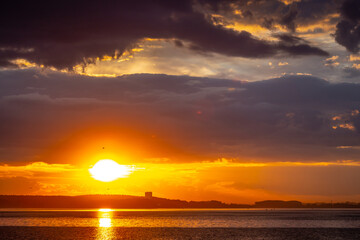 Red sunset over the sea, rich in dark clouds