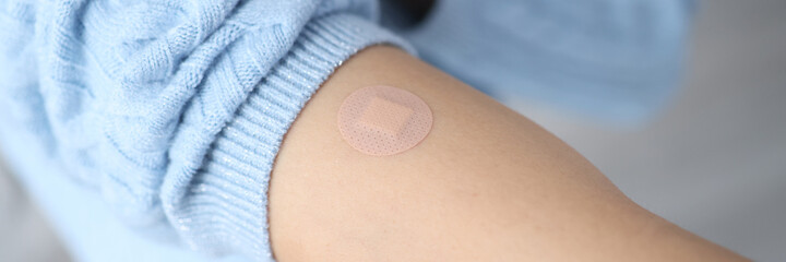 Female hand after vaccination with sealed plaster