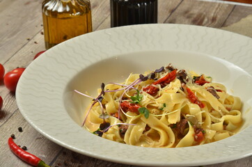Pasta Fettuccine with tomato and cheese in white bowl. on wooden rustic background