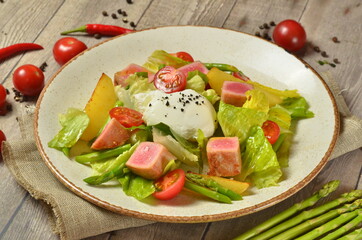 fresh tuna Nicoise fish salad with vegetables and avocado on wooden background