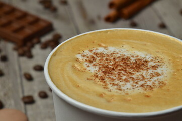 Top view of Latte hot coffee (or cappuccino) roasted coffee beans and ingredients on wooden table