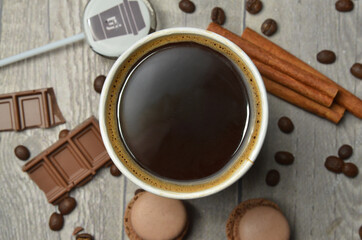 Top view of Latte hot coffee (or cappuccino) roasted coffee beans and ingredients on wooden table