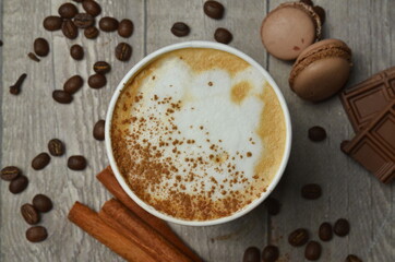 Top view of Latte hot coffee (or cappuccino) roasted coffee beans and ingredients on wooden table