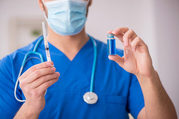 Fototapeta premium Young male doctor in vaccination concept during pandemic