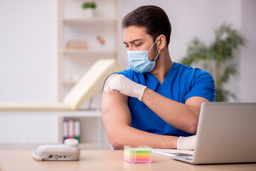 Young male doctor in vaccination concept