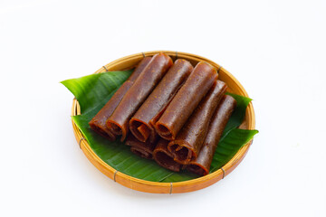 Dried mango paste in bamboo basket on white
