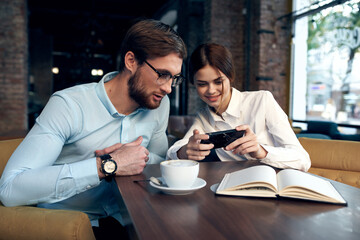 Business couple sitting at a table in a cafe breakfast communication work