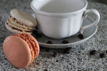 isolated cup of coffee macaroons and coffee beans dessert