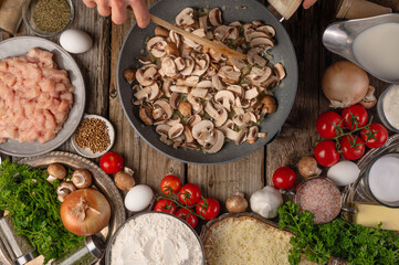 In the photo, the chef fries mushrooms in a skillet. We also see many other ingredients on the...