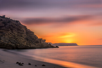 Colorful sky at morning with rock before sunrise at praia da Figueira, Portugal