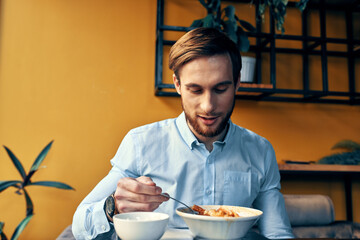 man eating lunch at cafe table break at work and interior