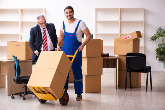 Old businessman and young contractor in relocation concept