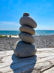 Cairn of Beach Pebbles on Driftwood