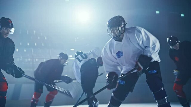 Ice Hockey Rink Arena: Professional Defender Player Attacks, Pushing Attacker Aggressively, Trying to take the Puck. Competitive Intense Game with Skill, Speed, Energy, Power. Cinematic Slow Motion