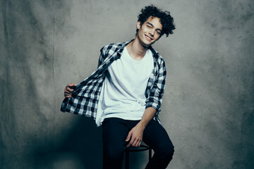 Cheerful guy curly hair plaid shirt studio cropped look lifestyle