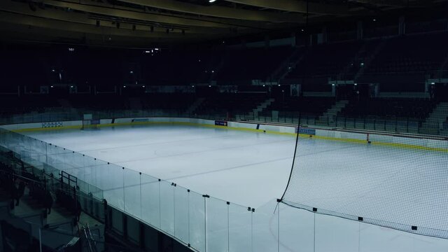 Empty Professional Ice Hockey Arena with Lights Turning On. Big Rink Stadium Ready for the Championship to Begin. Establishing Shot