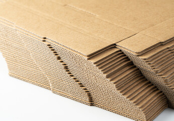 A lot of pre-assembled cardboard boxes stacked on a white background.