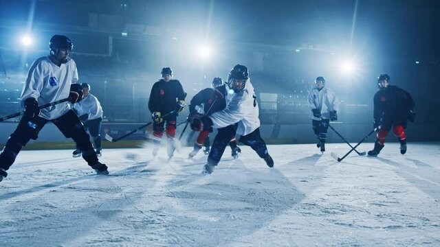 Ice Hockey Rink Arena: Successful Pass for Forward Player who Does Slapshot, Shots Puck with Stick and Scores a Goal with a PowerWide Hit. Goals Off Camera. Cinematic Slow Motion Wide Shot