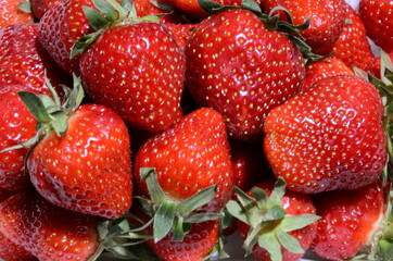 Ripe appetizing juicy strawberries are shot close-up.