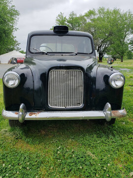 Vintage Car Austin FX4 Stands On Green Grass