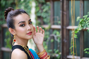 Portrait of beautiful young asian Thai girl. Woman model with traditional India costume.