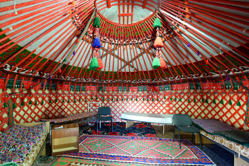 Inside view of a yurt in Bokonbayevo, Kyrgyzstan. Circular tent used as a house by dungan and nomadic groups in Central Asia. Ger interior. - obrazy, fototapety, plakaty