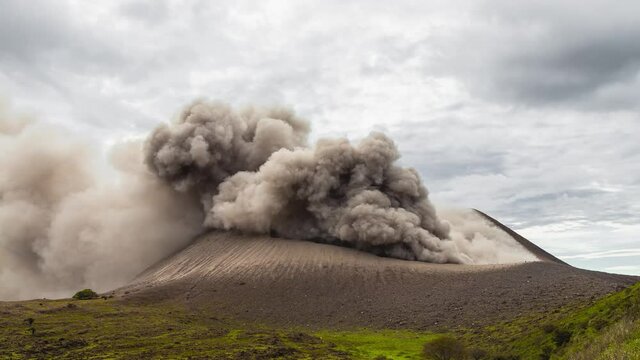 Wide tilt down time lapse volcano heavy eruption on cludy day, Telica, Nicaragua