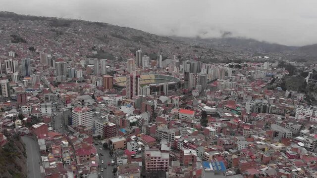 Low rotating aerial over La Paz shows Olympic Stadium Hernando Siles