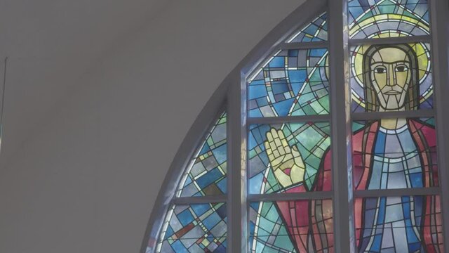 Colorful church window with an image of Jesus Christ