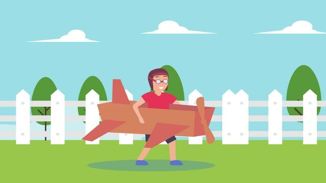 Little boy playing with a cardboard airplane