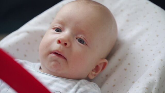 Face of an unhappy baby, 3 month old newborn infant baby boy is ready to cry. High quality 4k footage